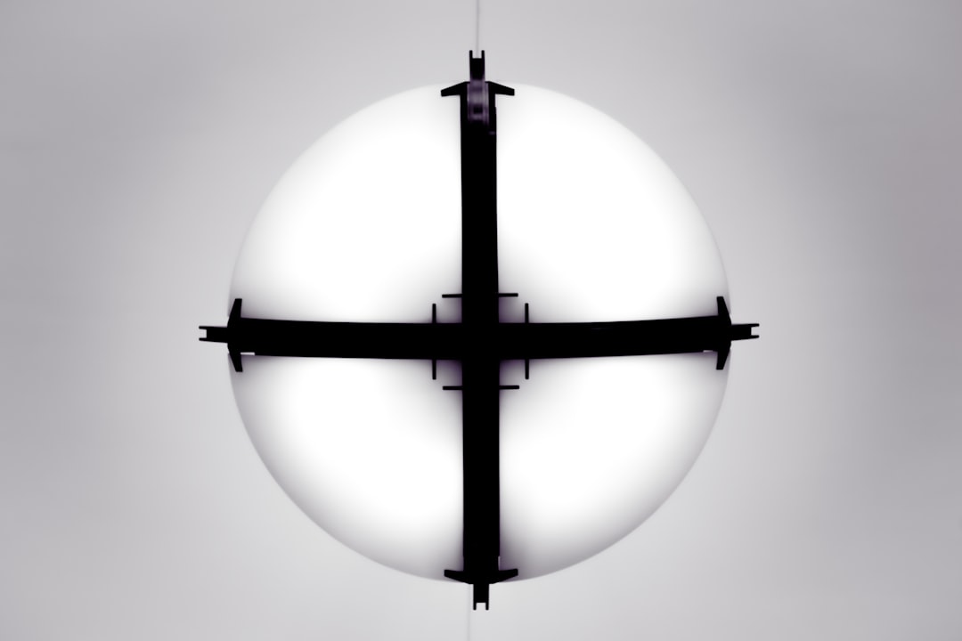 a-white-sphere-with-black-crossbars-against-a-gray-background-tjfwoxm5-mo